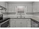 Renovated kitchen with granite countertops and white cabinets at 6641 Melody Ln, Charlotte, NC 28215