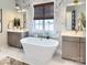 Luxurious bathroom with marble tile, soaking tub, and dual vanities at Lot 51 Rivermist Dr # Nottingham, Belmont, NC 28012