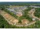 Aerial view of new construction community with green spaces and foundations being built in the neighborhood at Lot 51 Watercourse Way # Arcadia, Belmont, NC 28012