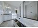 Bright bathroom featuring dual vanities, a soaking tub with granite surround, and a glass-enclosed shower at Lot 51 Watercourse Way # Arcadia, Belmont, NC 28012