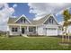 Inviting home featuring a covered porch, gray siding, and a three-car garage at Lot 51 Watercourse Way # Arcadia, Belmont, NC 28012