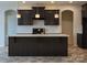 Contemporary kitchen with dark wood cabinets, an island, and stainless steel fixtures at Lot 51 Watercourse Way # Arcadia, Belmont, NC 28012