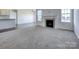 Cozy living room with a fireplace, large windows, and neutral-toned carpeting at Lot 51 Watercourse Way # Arcadia, Belmont, NC 28012