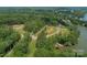 Beautiful aerial view of a waterfront neighborhood lot surrounded by lush trees and a winding road at Lot 51 Watercourse Way # Covington, Belmont, NC 28012