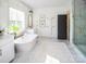 Elegant bathroom featuring a soaking tub, marble accents, and a modern design at Lot 51 Watercourse Way # Covington, Belmont, NC 28012