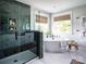 Modern bathroom showcasing a glass-enclosed shower, soaking tub, and serene decor at Lot 51 Watercourse Way # Covington, Belmont, NC 28012