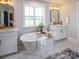 Stylish bathroom with a freestanding tub, double vanity, and modern gold fixtures at Lot 51 Watercourse Way # Covington, Belmont, NC 28012