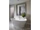 Bright bathroom featuring a standalone tub with tile floor and a walk-in shower at Lot 51 Watercourse Way # Covington, Belmont, NC 28012