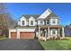 Attractive two-story house boasting gray siding, white trim, a covered porch, and an attached three-car garage at Lot 51 Watercourse Way # Covington, Belmont, NC 28012