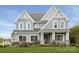 Charming two-story home showcasing gray siding, white trim, a covered porch, and a meticulously landscaped yard at Lot 51 Watercourse Way # Covington, Belmont, NC 28012