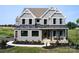 Stately two-story home displaying gray siding, black trim, a welcoming porch, and a convenient two-car garage at Lot 51 Watercourse Way # Covington, Belmont, NC 28012