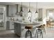Kitchen featuring a center island, gray cabinets, modern backsplash, and stainless steel appliances at Lot 51 Watercourse Way # Covington, Belmont, NC 28012