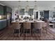 Bright kitchen showcases a spacious center island with seating and stylish pendant lighting at Lot 51 Watercourse Way # Covington, Belmont, NC 28012