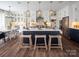 Open concept kitchen with large island, white cabinets, stainless appliances, and wood-look floors at Lot 51 Watercourse Way # Covington, Belmont, NC 28012