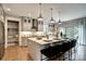 Elegant kitchen with a large center island, seating, stainless appliances, and plenty of cabinet space at Lot 51 Watercourse Way # Covington, Belmont, NC 28012