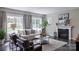 Sun-filled living room featuring a fireplace, plush seating, and large windows with a view at Lot 51 Watercourse Way # Covington, Belmont, NC 28012