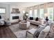 Cozy living room features a fireplace, large windows, and comfortable seating at Lot 51 Watercourse Way # Covington, Belmont, NC 28012