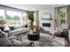 Bright living room featuring a fireplace, large windows with views, and comfortable seating at Lot 51 Watercourse Way # Covington, Belmont, NC 28012