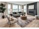 Living room with a modern fireplace, large windows, and comfortable seating arrangement at Lot 51 Watercourse Way # Covington, Belmont, NC 28012