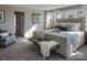 Light-filled bedroom featuring a stylish bed, soft gray carpet, and a cozy sitting area at Lot 51 Watercourse Way # Covington, Belmont, NC 28012