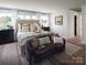 Cozy bedroom with soft lighting, neutral decor, and a comfortable seating area at Lot 51 Watercourse Way # Covington, Belmont, NC 28012