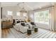 Bright main bedroom features vaulted ceilings, chandelier, large windows, and seating area at Lot 51 Watercourse Way # Nottingham, Belmont, NC 28012