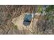 Aerial view of a home nestled amongst trees, featuring a long driveway and spacious surroundings at 149 Pinewood St, Troutman, NC 28166
