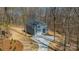 Aerial view of a two-story home with gray siding and a long driveway surrounded by trees at 149 Pinewood St, Troutman, NC 28166