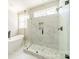 Elegant bathroom featuring a glass shower, marble tiling, and a modern soaking tub at 149 Pinewood St, Troutman, NC 28166