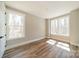 Bright, empty bedroom with hardwood floors and ample natural light at 149 Pinewood St, Troutman, NC 28166