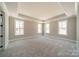 Spacious, light-filled main bedroom with tray ceilings and neutral carpet at 149 Pinewood St, Troutman, NC 28166