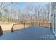 Spacious wooden deck with black railings, surrounded by a backdrop of trees and foliage at 149 Pinewood St, Troutman, NC 28166