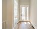 Entryway with hardwood floors, leading to a room with lots of light and a glass door at 149 Pinewood St, Troutman, NC 28166