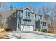 Two-story home with a white garage door, gray siding, and white trim, with well-manicured landscaping at 149 Pinewood St, Troutman, NC 28166