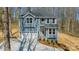 Two-story home with white garage door and gray siding, complemented by a green landscaped front yard at 149 Pinewood St, Troutman, NC 28166