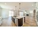 Kitchen island with stainless steel sink and view of a living space at 149 Pinewood St, Troutman, NC 28166