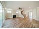 Spacious living room featuring a fireplace, ceiling fan, and sliding glass doors at 149 Pinewood St, Troutman, NC 28166