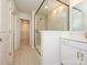 Bathroom featuring glass enclosed shower, double vanity, quartz countertop and access to closet at 157 Halite Ln, Waxhaw, NC 28173