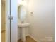 Stylish pedestal sink in powder room featuring modern fixtures and neutral tones at 157 Halite Ln, Waxhaw, NC 28173
