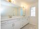 Bright bathroom featuring double vanity, white cabinets, granite countertop, and gold hardware at 157 Halite Ln, Waxhaw, NC 28173
