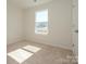 Bright bedroom with neutral carpet, large window, and fresh paint, ready for new decor at 157 Halite Ln, Waxhaw, NC 28173