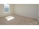 Bedroom with neutral carpeting, a window providing natural light, and electrical outlets ready for use at 157 Halite Ln, Waxhaw, NC 28173