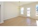 Sunlit dining area featuring hardwood floors, modern chandelier, and a walkout to the backyard at 157 Halite Ln, Waxhaw, NC 28173
