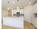 Bright, modern kitchen boasts a spacious island, stainless steel appliances, and stylish pendant lights at 157 Halite Ln, Waxhaw, NC 28173
