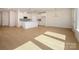 Expansive living room with hardwood floors, a stylish island, and ample space for entertaining at 157 Halite Ln, Waxhaw, NC 28173