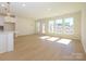 Spacious living room featuring an open floor plan, hardwood floors, and plenty of natural light at 157 Halite Ln, Waxhaw, NC 28173