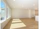 Large living room with generous windows and hardwood floors that bring in ample light at 157 Halite Ln, Waxhaw, NC 28173