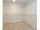 Walk-in closet, carpeted, featuring white walls and wire shelving, providing ample storage space at 157 Halite Ln, Waxhaw, NC 28173