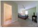 Inviting bedroom with carpet and soft green walls with an attached ensuite bathroom at 2031 Sandy Pond Ln, Waxhaw, NC 28173