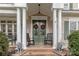 Inviting front porch featuring rocking chairs, lion statues, and festive wreaths at 2031 Sandy Pond Ln, Waxhaw, NC 28173